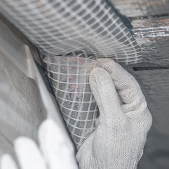 hands working with vapor barrier