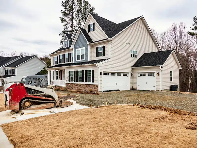 house with bobcat in driveway