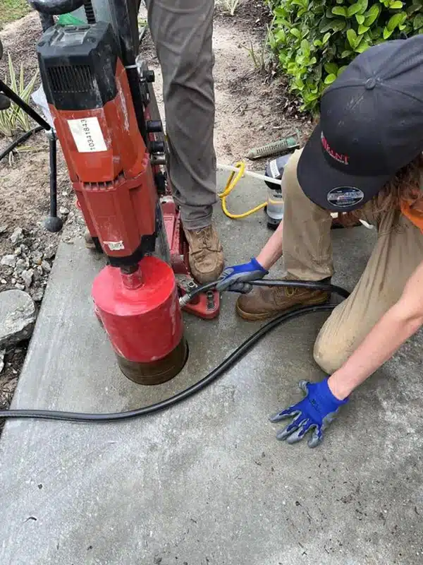 man using equipment on concrete